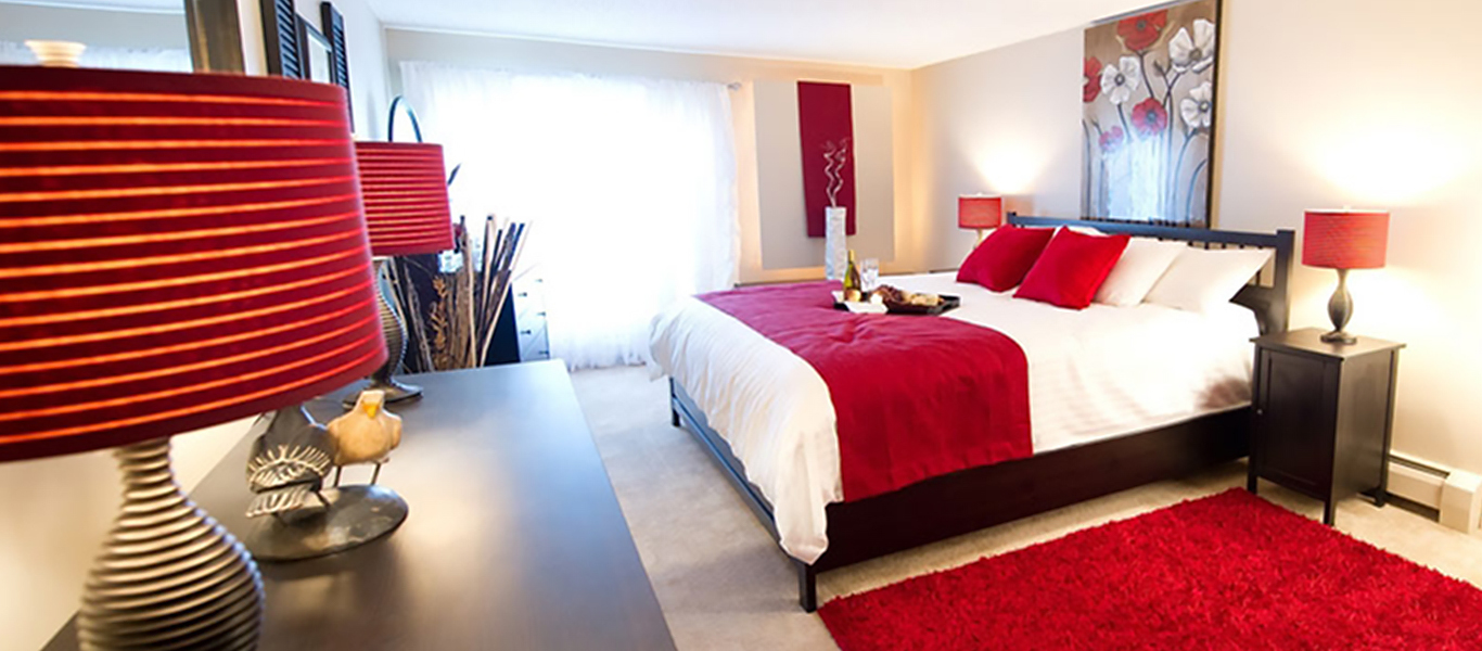 Decorated apartment bedroom with red and white color scheme